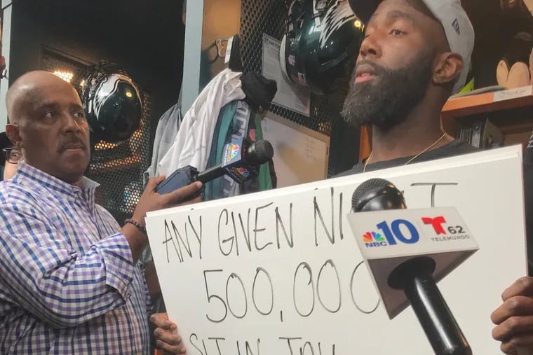 The Eagles' Malcolm Jenkins chose to speak to the media by holding up signs the day after the team was supposed to visit the White House. 