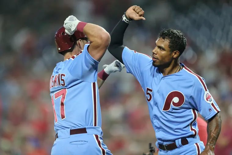 Phillies' outfielder Rhys Hoskins celebrates his three-run homer with Nick Williams during the team's win in the second game of a doubleheader against the Mets.