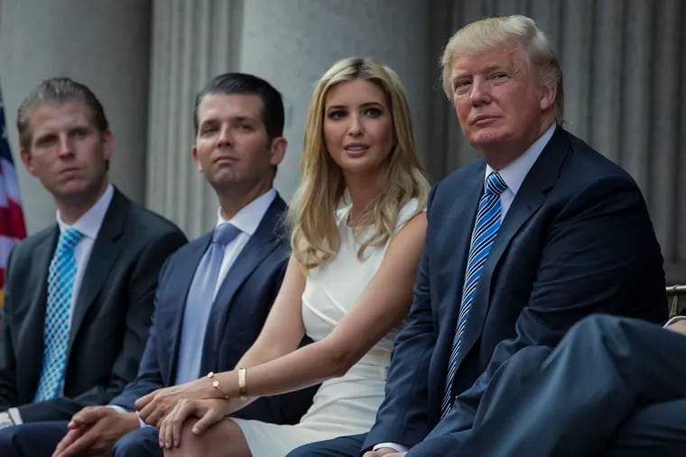 Donald Trump, right, shown sitting with his children, from left, Eric Trump, Donald Trump Jr., and Ivanka Trump during a groundbreaking ceremony for the Trump International Hotel on July 23, 2014, in Washington.
