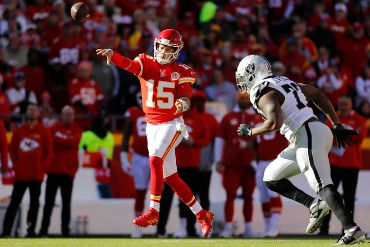 Kansas City QB Patrick Mahomes throws the ball for a completion while under pressure from Quinton Jefferson of the Las Vegas Raiders at Arrowhead Stadium on December 12, 2021 in Kansas City, Missouri. (Photo by David Eulitt/Getty Images)