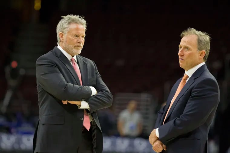 Sixers coach Brett Brown, left, and managing partner Josh Harris before an April game against the Bucks.