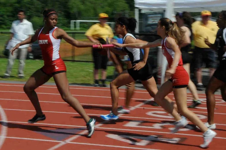 Lenape's Evann Thompson takes the baton from Anna DeLasheras in the second leg of the 4x400 relay. The Lenape girls won the Group 4 title with 107 points, overcoming Southern Regional.