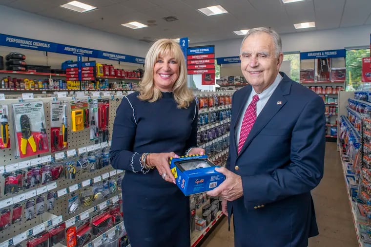 Beth Beans Gilbert and her father Fred Beans, 80, pose for a photograph in one of the aisles of their CarQuest store Tuesday, October 08, 2019. WILLIAM THOMAS CAIN / For The Inquirer