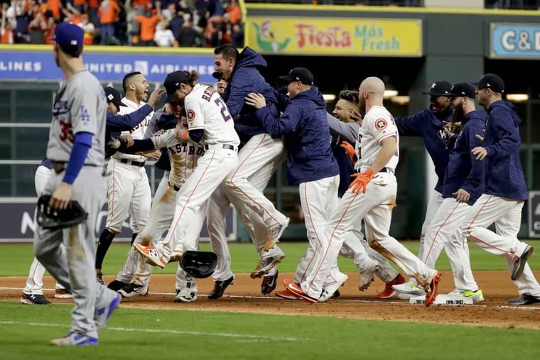 The Houston Astros celebrates after Alex Bregman game winning single during Game 5 of baseball's World Series against the Los Angeles Dodgers Monday, Oct. 30, 2017, in Houston. Astros won 13-12. (AP Photo/Matt Slocum)