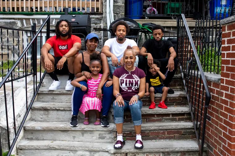 Joanna Horton, 53, of Logan, Philadelphia,(front right), poses for a portrait with her kids Kaleif Horton, 27, (back left), Christopher Horton, 30, (back center), Lee Horton, 32, Joanna Horton, 28, (front left), and her grandkids, Farrah Finney, 6, (front left), and Lamar Horton, 3, (back right), in front of her home on Friday, Aug., 28, 2020. Joanna and her family have been waiting for 27 years for the release of her husband Lee Horton and his brother Dennis Horton.