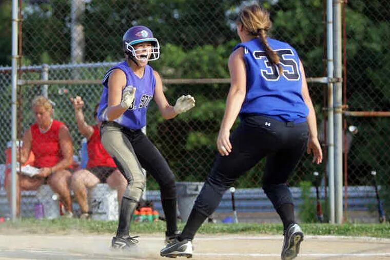 Central Bucks South baserunner Ally Horvath is greeted by Morgan Decker (35) after she slid across home plate with the winning run in the 10th inning. Horvath scored on a bunt by Shana Steigerwalt.
