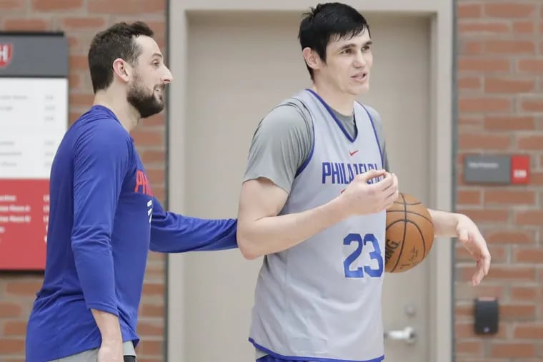 Sixers forward Ersan Ilyasova (right) with teammate guard Marco Belinelli after practice in Lavietes Pavilion at Harvard University on Wednesday.