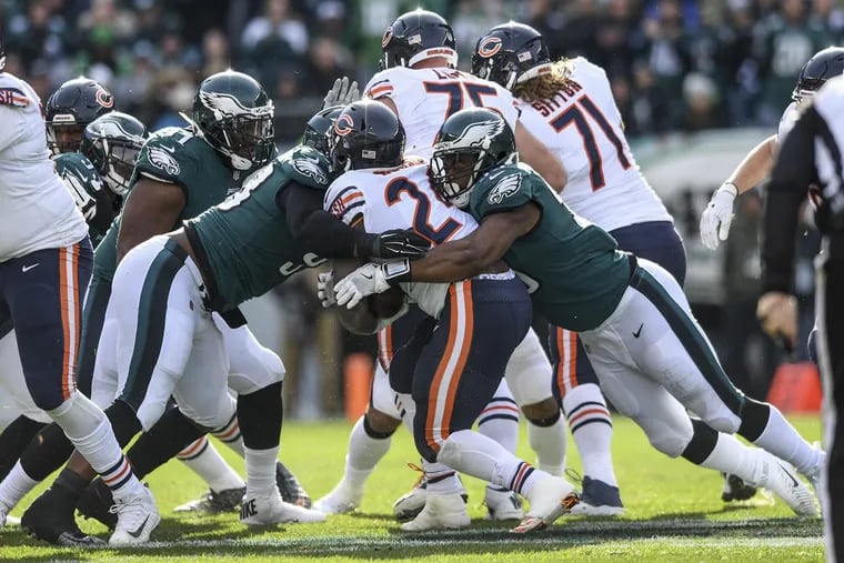 Eagles defensive linemen Tim Jernigan (left) and Brandon Graham (right) stop Chicago running back Jordan Howard for a 1-yard loss on 3rd and 2 in the 1st quarter of the game November 26, 2017 at Lincoln Financial Field. Eagles won 31-3. CLEM MURRAY / Staff Photographer
