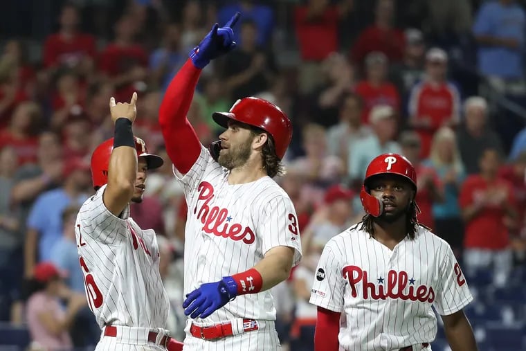 Bryce Harper, center, of the Phillies celebrates with Cesar Hernanadez, left, and Roman Quinn after Harper’s 3-run home run against the Padres in the 6th inning  at Citizens Bank Park on Aug. 16, 2019.