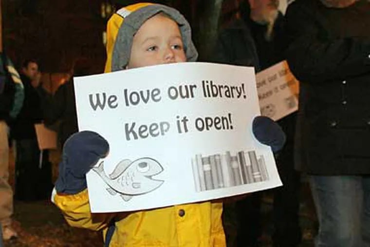Ryan Ganzel, 4, holds a sign during a rally to save the Fishtown library branch on Monday. (Yong Kim / Staff Photographer)