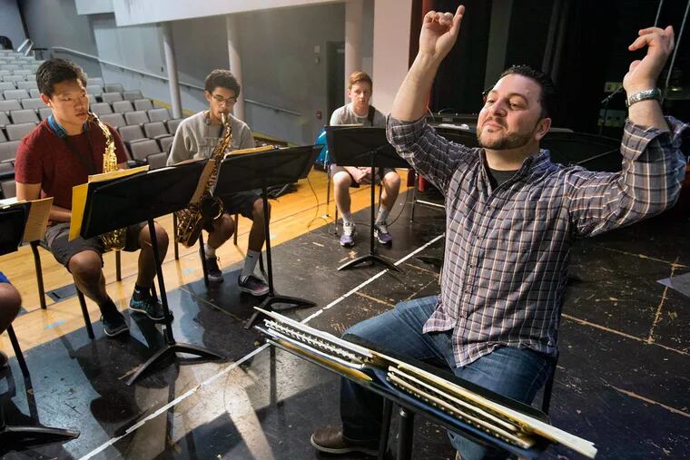 Band director David DiValentino conducts a practice session days before the New Orleans trip.