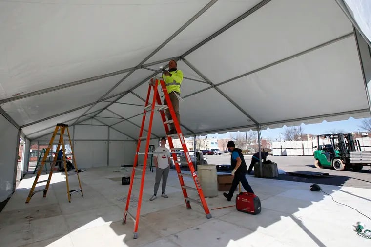 Workers prepare a vaccination tent in the parking lot of Esperanza in North Philadelphia.  FEMA is to open second COVID-19 vaccine site at the North Philadelphia nonprofit organization that serves the Hispanic community.