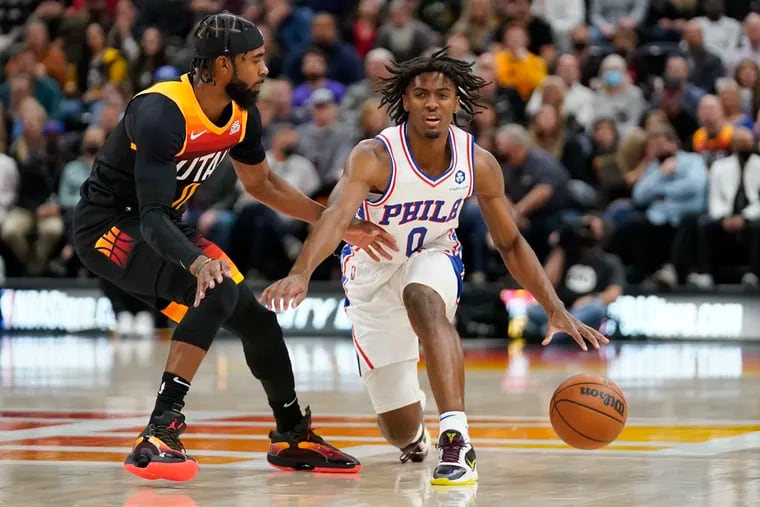 Philadelphia 76ers guard Tyrese Maxey (0) drives as Utah Jazz guard Mike Conley, left, defends during the first half of an NBA basketball game Tuesday in Salt Lake City. (AP Photo/Rick Bowmer)