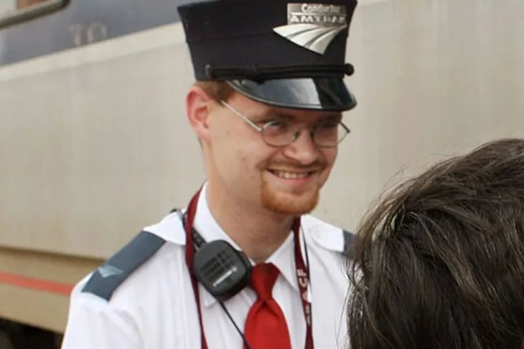 This Aug. 21, 2007 photo shows Amtrak assistant conductor Brandon Bostian outside a train at the Amtrak station in St. Louis. Bostian was the engineer in the fatal Tuesday, May 12, 2015 passenger train derailment in Philadelphia. (Huy Richard Mach/St. Louis Post-Dispatch via AP)