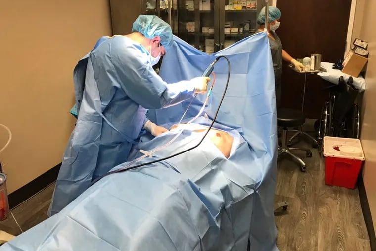 Marwan Khalifeh, a Washington-area cosmetic surgeon, performs a breast reduction procedure on a male patient. Khalifeh is seeing more men who want to reduce their breast size.