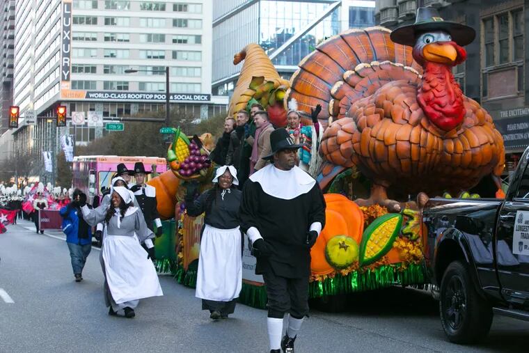 A turkey float and parade participants make their way down JFK Boulevard at the 98th Annual 6ABC Dunkin' Donuts Thanksgiving Day Parade, Thursday, Nov. 23, 2017.