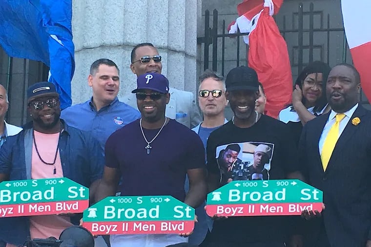 Members of Boyz II Men (from left) Wanya Morris, Nate Morris and Shawn Stockton joined city officials Saturday to unveil a replica of street sign renaming Broad Street between Christian and Carpenter Streets in their honor.