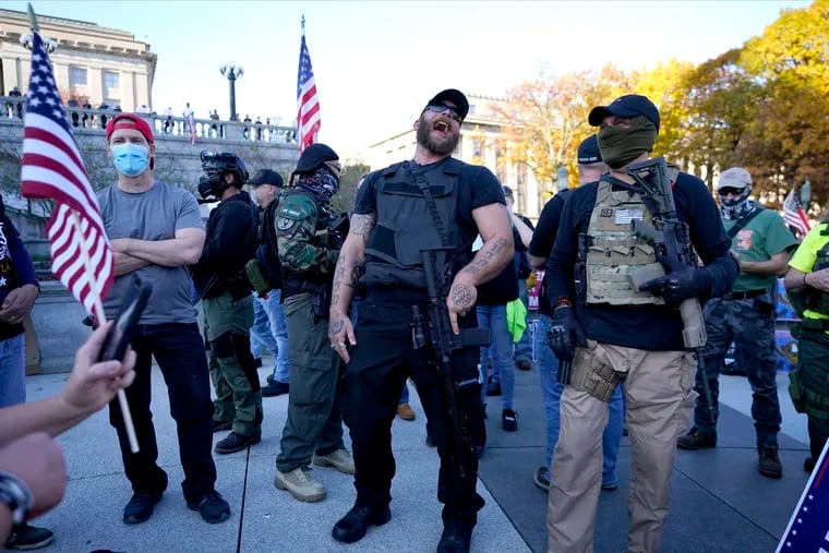Supporters of President Donald Trump carry firearms while demonstrating outside the Pennsylvania State Capitol, Saturday, Nov. 7, 2020, in Harrisburg, after Democrat Joe Biden defeated Trump to become 46th president of the United States.