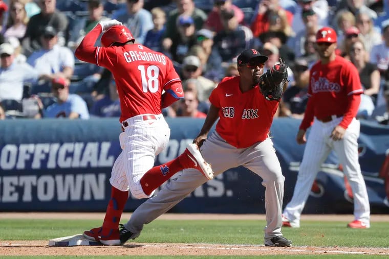 Phillies Didi Gregorius touches first base against Boston Red Sox first baseman Josh Ockimey during a spring training game in Clearwater, Florida on Saturday, March 7, 2020.