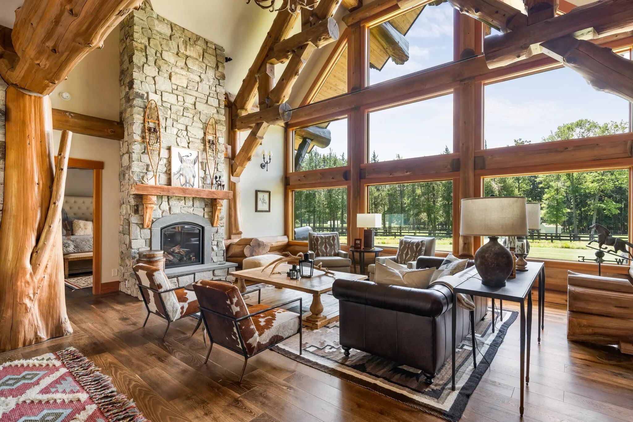 The A-frame great room shows how much of the natural shape of the wood was retained when building the house, which is what the Rodriguezes wanted to emphasize a linkage to the outdoors. The floor-to-ceiling windows add to the effect, offering a view that changes with the seasons.