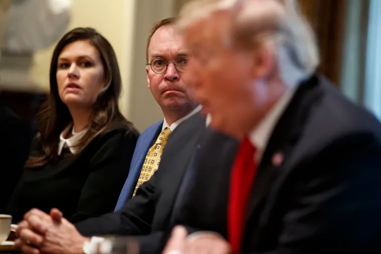 White House press secretary Sarah Sanders and acting White House Chief of Staff Mick Mulvaney listen as President Donald Trump speaks during a meeting with NATO Secretary General Jens Stoltenberg in the Cabinet Room of the White House on April 2.