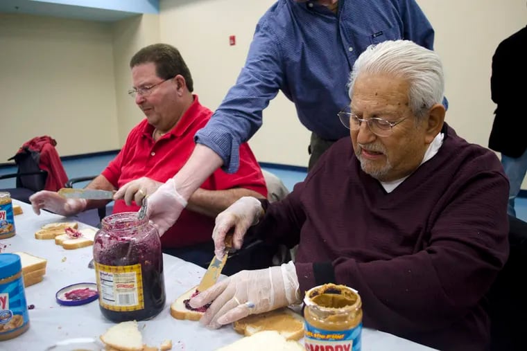 Ed Gotleib, right, aids the South Jersey Men's Club in making peanut butter and jelly sandwiches to offer to nonviolent offenders with outstanding warrants who turn themselves in under the "Safe Surrender" program. ( Richard Kauffman / Staff Photographer )