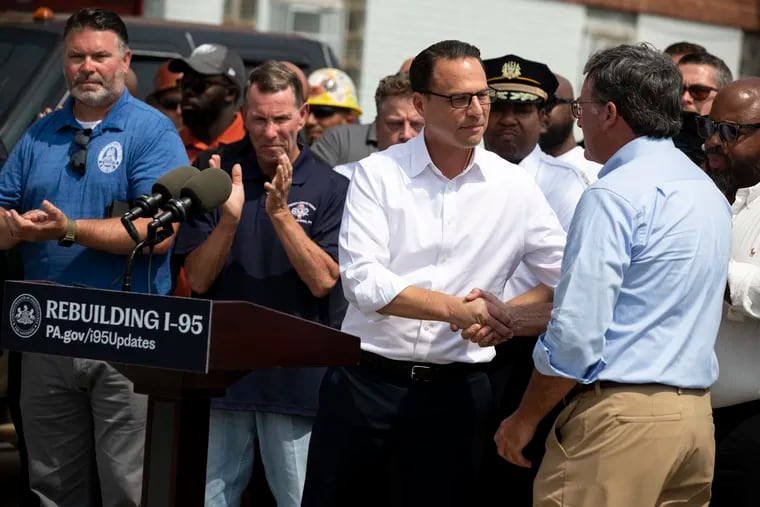 Governor Josh Shapiro greets Secretary of Transportation Mike Carroll during a press conference at the collapsed section of I-95 near Cottman and State Roads in Northeast Philadelphia, Pa. on Tuesday, June 20, 2023. Earlier this month, a tanker filled with gasoline crashed and exploded underneath the northbound lanes of I-95, leading to the collapse. Shapiro announced that the interim roadway will open to drivers this weekend.