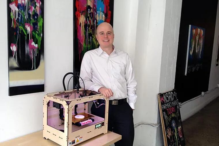 Chris Cera, founder of Arcweb, stands next to MakerBot 3-D printer.  Arcweb worked on the software that ships with the printer. (Michael Hinkelman / Daily News Staff)