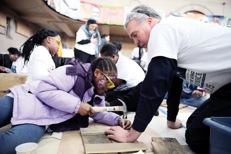 Frank Monaghan, executive director of Habitat for Humanity, right, helps Janai Wright, 9, left, build a flower box during 20th annual Greater Philadelphia Martin Luther King Day of Service on Jan. 19, 2015 at Girard College.