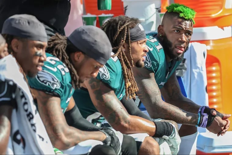 Eagles cornerback Jalen Mills, right, and other defensive backs take the bench in the fourth quarter after having a hard day in Nashville against the Titans. Avonte Maddox is seated next to Mills.  Sunday September 30, 2018, 26-23 in overtime. . MICHAEL BRYANT / Staff Photographer