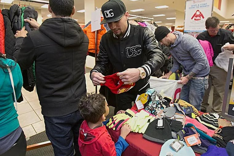 Danny Garcia was at the Burlington Coat Factory's Center City store this morning handing out winter coats to families in need. (Ed Hille/Staff Photographer)