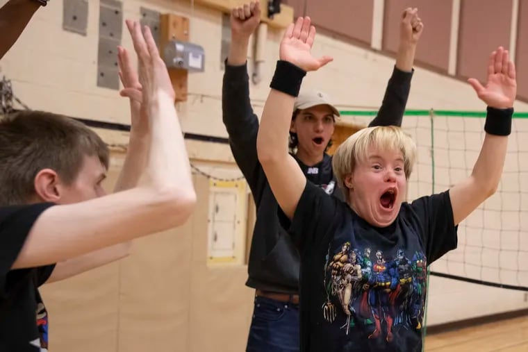 Katie Moore reacts after scoring a point for her team during a Special Olympics volleyball practice at the Bryn Athyn Church school in April. Arcadia University students and the Montgomery County Special Olympics volleyball program partner to host these practices.