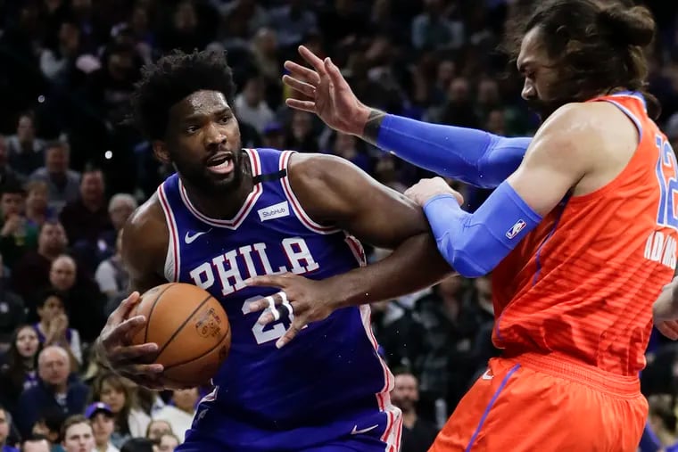 Sixers center Joel Embiid commits an offensive foul against Oklahoma City center Steven Adams during the second quarter.Philadelphia.