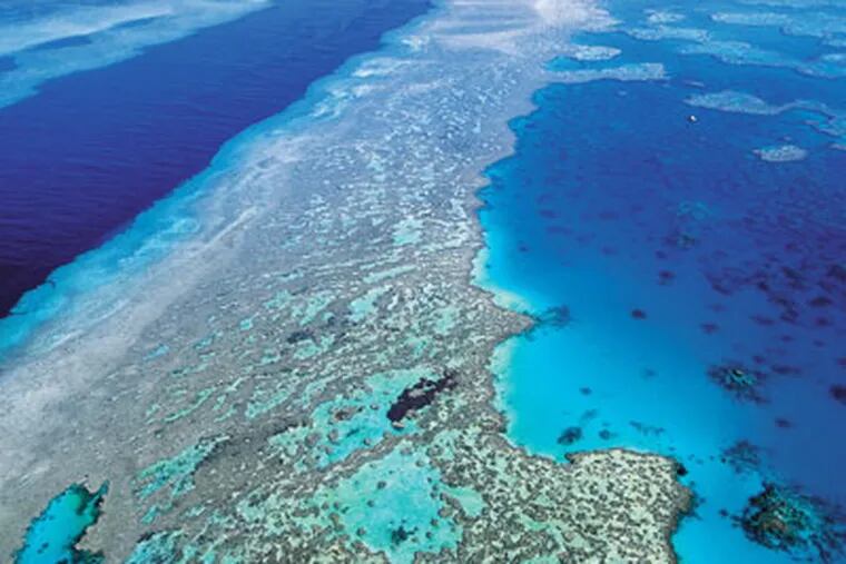 FILE -An aerial view shows the Great Barrier Reef off Australia's Queensland state. Ocean acidification has emerged as one of the biggest threats to coral reefs across the world, acting as the "osteoporosis of the sea" and threatening everything from food security to tourism to livelihoods. (AP Photo/Queensland Tourism, File)