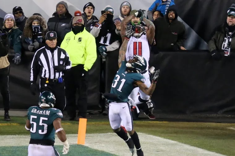Falcons wide receiver Julio Jones (11) couldn’t catch a pass under pressure from Eagles cornerback Jalen Mills (31) late in the Eagles' playoff win against the Falcons at Lincoln Financial Field on Jan. 13.