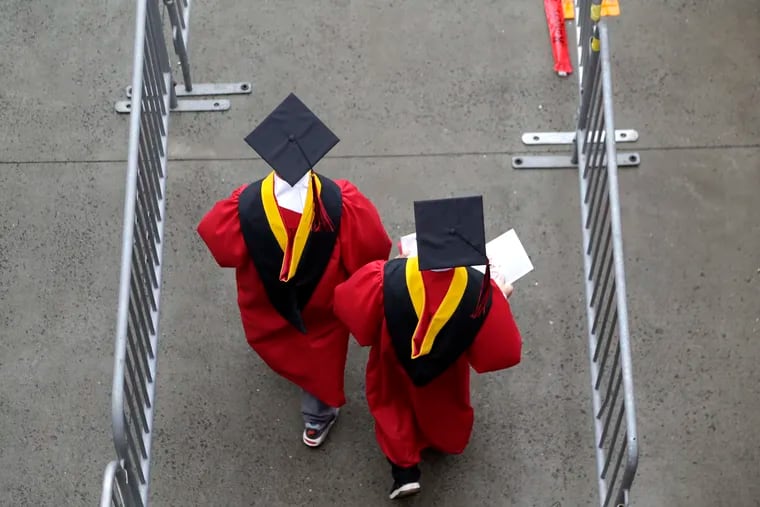 FILE - New graduates walk into the High Point Solutions Stadium before the start of the Rutgers University graduation ceremony in Piscataway Township, N.J., on May 13, 2018. President Joe Biden is expected to announce Wednesday that many Americans can have up to $10,000 in federal student loan debt forgiven.