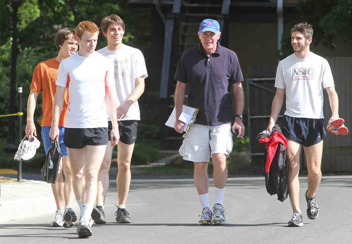 Tom Donnelly walks to practice with members of his team. "As a coach, you influence [athletes] by 1 percent, maybe," he said.