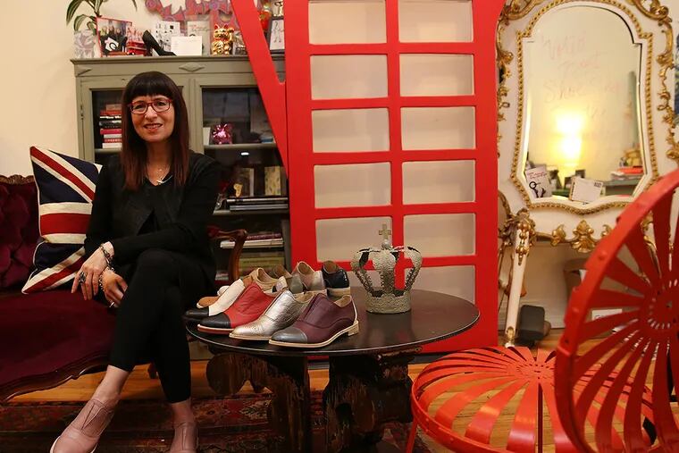 Elena Brennan, owner of Bus Stop shoe boutique, sits near a sample of her new line of shoes inside her shop located on 4th Street in Queen Village in Philadelphia, Pa., on Feb. 27, 2015. (David Maialetti / Staff Photographer )