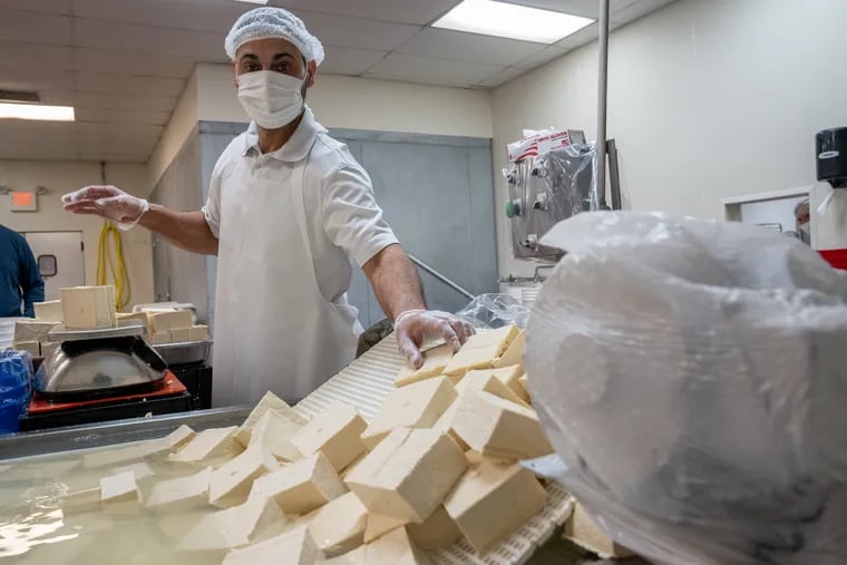 Edwin Lopez, a member of the production team at Fresh Tofu Inc. in Allentown, prepares tofu for packaging October 29, 2021.