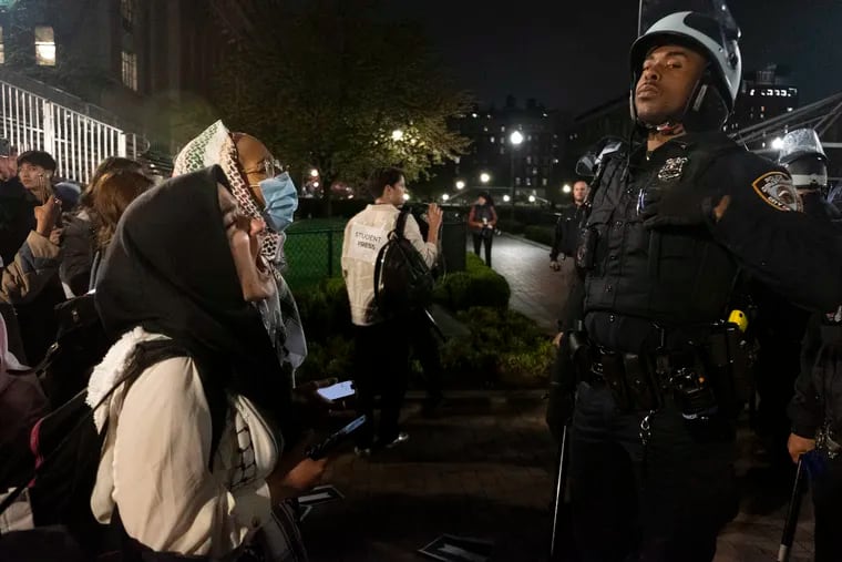 Pro-Palestine student activists face off with New York Police Department officers on Columbia University's campus last month.
