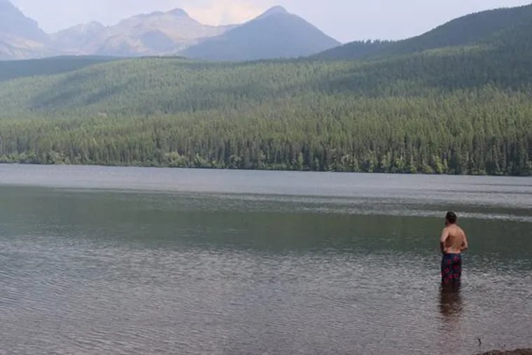 Brendan Cawley wading in Lake Bowman, Glacier Park, Montana