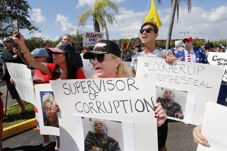 A crowd protests outside the Broward County Supervisor of Elections office Friday, Nov. 9, 2018, in Lauderhill, Fla. A possible recount looms in a tight Florida governor, Senate and agriculture commission race.