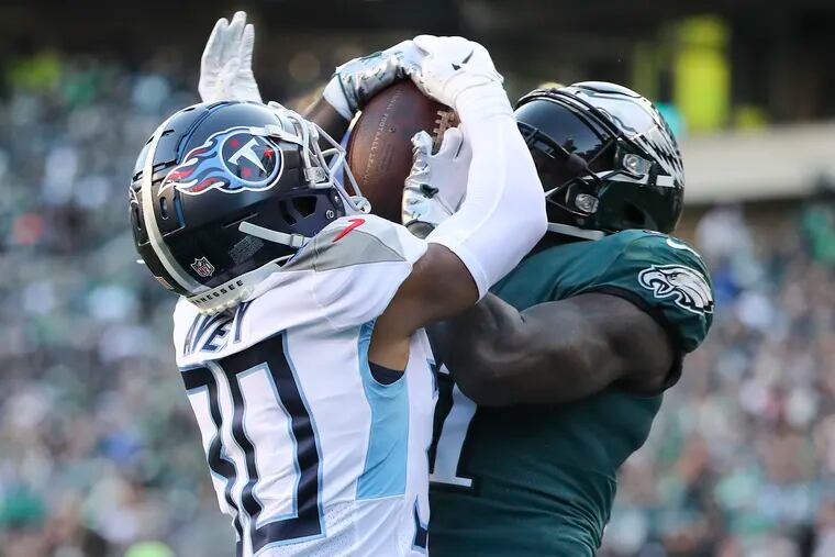 Eagles wide receiver A.J. Brown catches a third quarter touchdown past Tennessee Titans cornerback Tre Avery on Sunday, December 4, 2022 in Philadelphia.