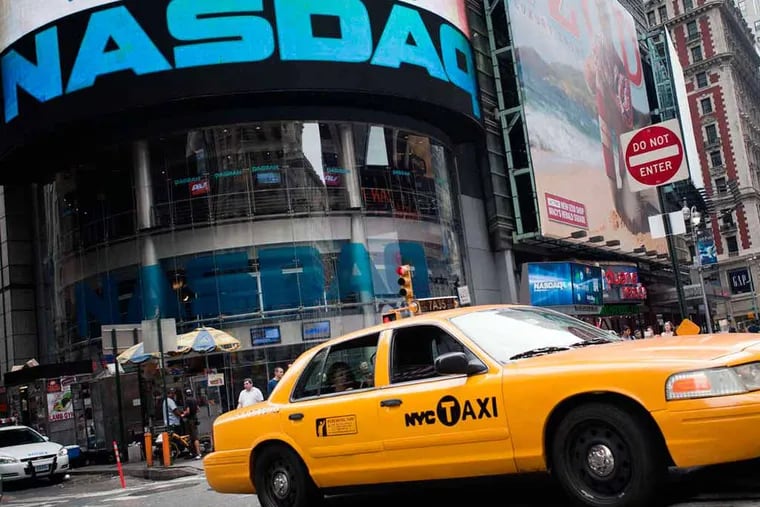 A taxi passes the Nasdaq MarketSite in New York, U.S., on Wednesday, July 13, 2011.