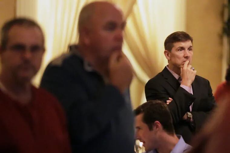 Frank Lojewski of Ridley Twp far right) watches the late returns at a local GOP election watching party  at a banquet hall at Barnaby's in Prospect Park, Pa. on Nov. 8, 2016.