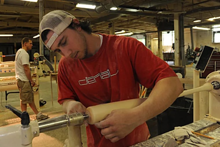 Dave Owen finish sands a bat at Rx Sport. High-end maple models are a specialty at the Norristown, Pa. company. (April Saul/Staff)