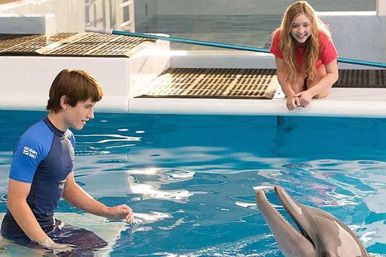 Nathan Gamble, Cozi Zuehlsdorff, and Winter (as herself) star in the sequel to the real-life tale of Winter's getting a prosthetic tail. (Warner Bros.)