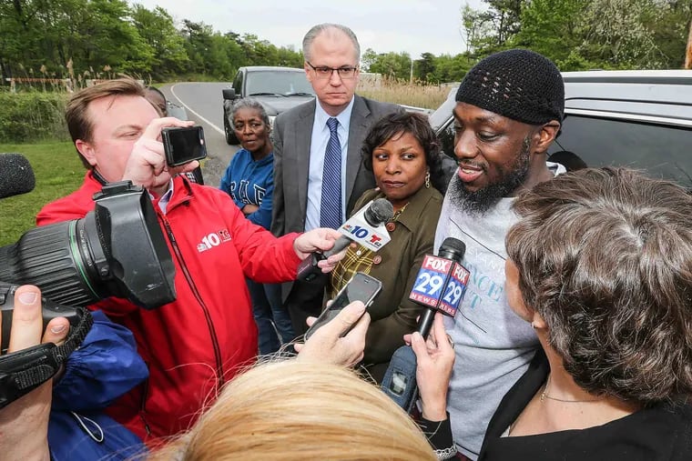 Reporters interview Shaurn Thomas (wearing skullcap) as relatives and lawyers stand nearby after his release from the State Correctional Institution at Frackville, in Schuylkill County, on Tuesday, May 23, 2017.