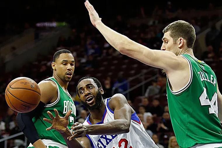 Luc Mbah a Moute passes the ball past the Celtics' Jared Sullinger (left) and Tyler Zeller. (Yong Kim/Staff Photographer)