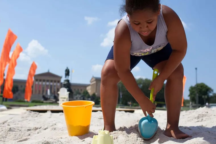 Peyton Moore, 8, gets some beach time at the Oval, a pop-up park in Eakins Oval.